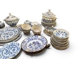a lot of blue and white plates and bowls on the table
