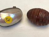 two small shells are sitting next to each other on a table