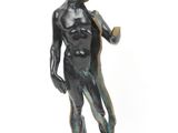 statue of a boy holding a baseball bat on a marble base