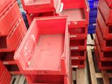many red boxes on a pallet in a warehouse