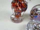 a glass vase with a bunch of different colored glass items in it