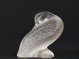 glass figurine of a bird on a black background