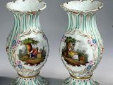 three vases sitting on a table with a painting on them
