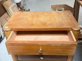 a wooden table with a drawer on it in the middle of a room