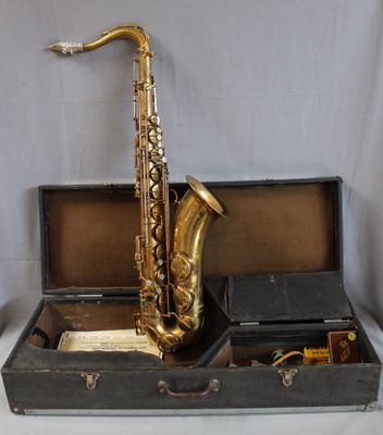 a saxophone sitting in a case on a table