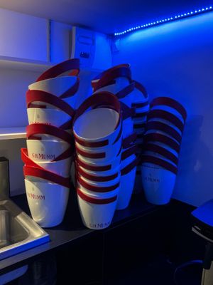 several cups are stacked on top of each other in a kitchen