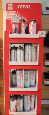 a red display case with cans and cans of paint on it