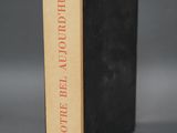 an old book sitting on top of a table next to a gray background