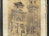 an old picture of a building with a clock tower in the background