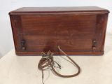 an old wooden box with a rope on it sitting on top of a table