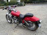 a red motorcycle that is parked in a parking lot