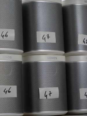 six tins with numbers on them sitting on a shelf