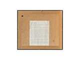 a close up of a piece of paper on a wooden surface