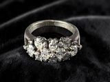 a close up of a diamond ring on a black cloth