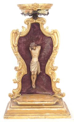 a statue of jesus on the cross on a stand