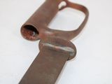 an old rusted metal object on a white surface
