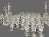a lot of wine glasses and a pitcher on the table