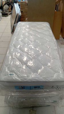 a mattress sitting on top of a box in a store