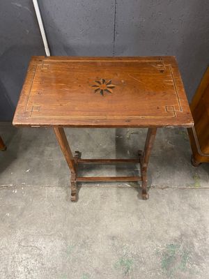 a small wooden table with a star design on it
