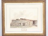 an old picture of a building in a frame on a table