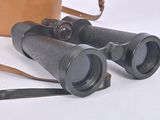 a pair of binoculars sitting on a table next to a cup