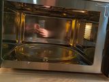 a man taking a picture of himself in the microwave