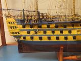 a model of a yellow and black ship on display