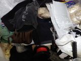 a pile of clothes in a plastic bag on the floor