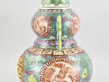 an image of a colorful vase with a bird on the top of it