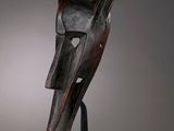 an image of a wooden mask on a black stand
