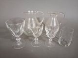 quatre verres et un pichet posés sur une table