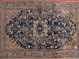 an antique persian rug with a floral design on a red ground