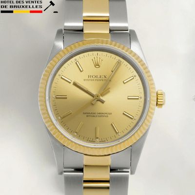 a watch that has a gold dial on it