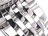 a close up of a watch on a white surface