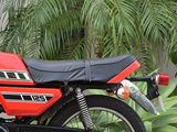 a red and black motorcycle parked in front of a building