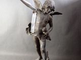 a statue of a boy with a bird on his arm