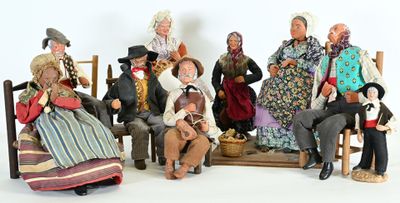 many figurines of people sitting on a bench