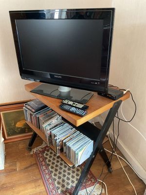 a flat screen tv sitting on top of a wooden stand