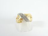 a close up of a gold ring with diamonds on a white surface
