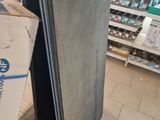 a refrigerator that is sitting in a store next to a box