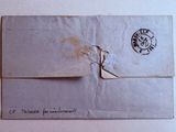 an old envelope with a stamp on it sitting on top of a table