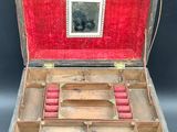 an old wooden box with red candles inside of it
