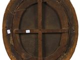 a round wooden window with a cross on it