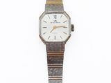 a watch that is sitting on a white surface