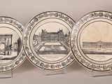 several plates with different designs on them on display on a table