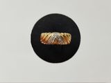a close up of a gold and diamond ring on a black surface