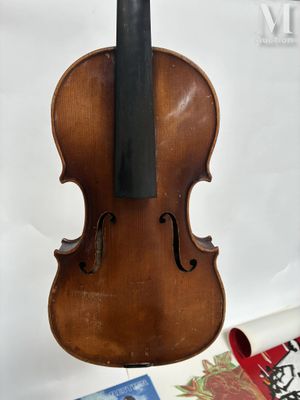a violin that is sitting on a table next to a book
