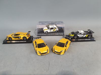 three yellow toy cars sitting on top of a table next to each other