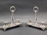 pair of silver plated candlesticks on stand