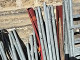 a pile of baseball bats sitting next to a brick wall